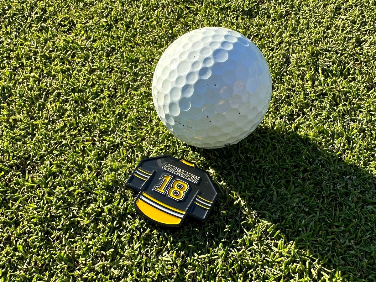 Custom metal golf divot tools and ball markers used for tournament gifts