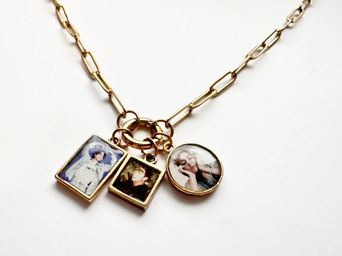 Hand holding a personalized metal pendant necklace