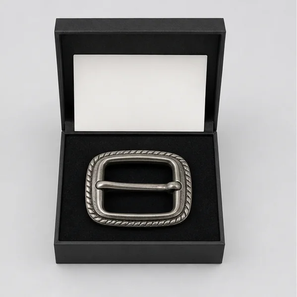 Antique silver belt buckle fitted inside an open rigid black gift box