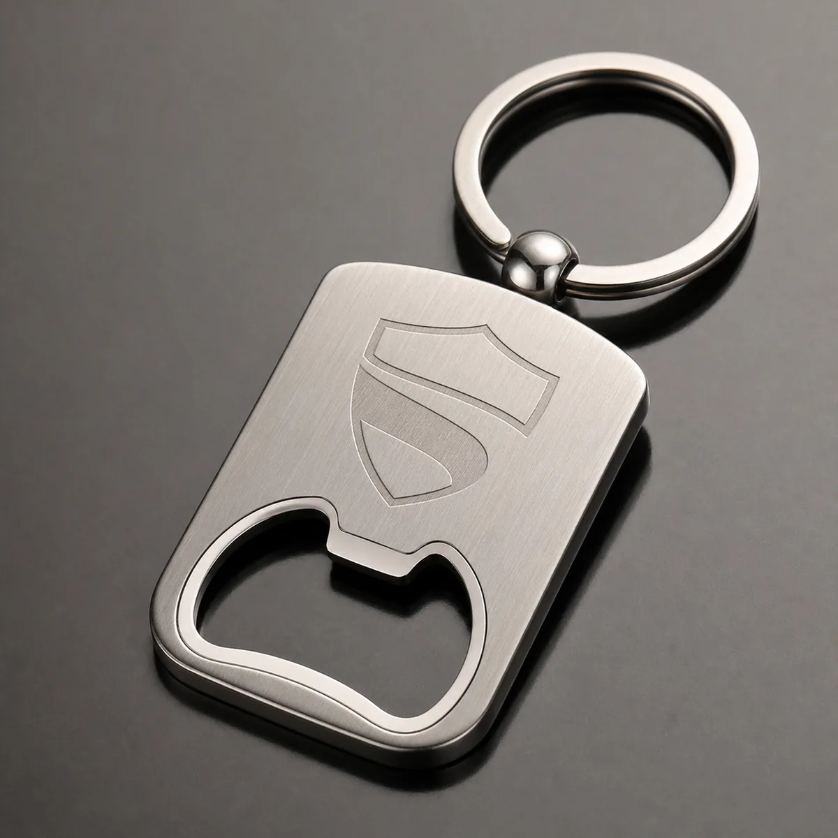 Custom stainless steel bottle opener keychain with brushed finish and engraved logo area